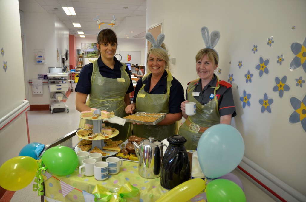 Lead nurses Leanne Mann and Sarah Causer serve tea and cakes to patients on Ward C3 with matron Rachel Tomkins